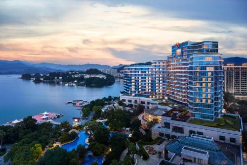 a view of a large building next to a body of water at Sheraton Qiandao Lake Resort in Thousand Island Lake