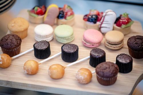 a bunch of different types of pastries and donuts on a table at Sheraton Brussels Airport Hotel in Zaventem