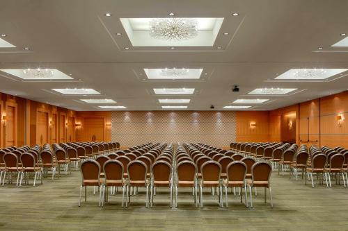 an empty room with rows of chairs in it at Sheraton Brussels Airport Hotel in Zaventem