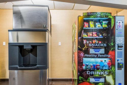 a drink vending machine next to a drink refrigerator at Comfort Inn & Suites Dayton North in Dayton