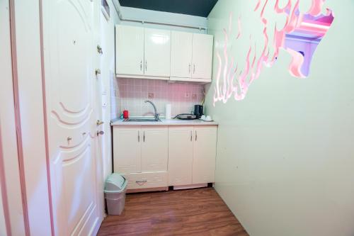 a small kitchen with white cabinets and a sink at Element Suites in Istanbul