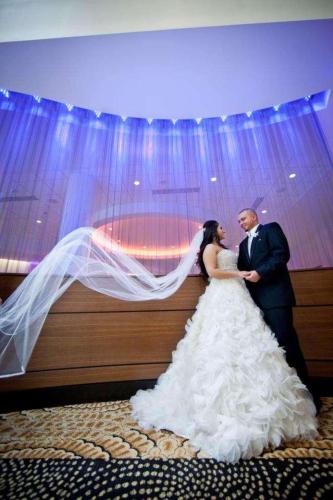 a bride and groom standing next to each other at Radisson Plaza Hotel at Kalamazoo Center in Kalamazoo