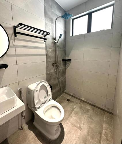 a bathroom with a toilet and a sink and a shower at Lodge 43 House in George Town