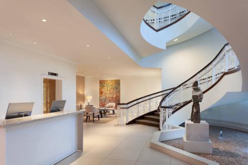 a lobby with a staircase with a statue at JW Marriott Miami Turnberry Resort & Spa in Aventura
