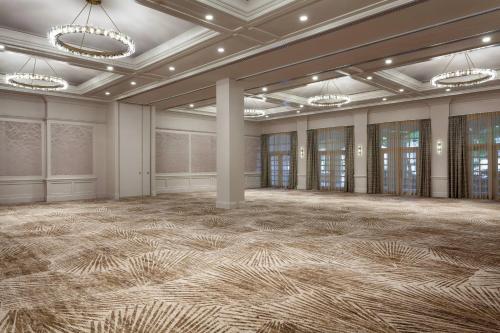 an empty ballroom with a large room with a carpeted floor at JW Marriott Miami Turnberry Resort & Spa in Aventura