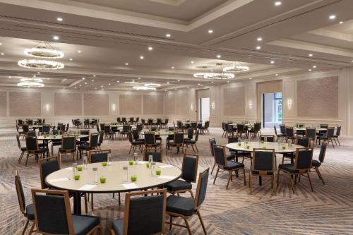 a banquet hall with tables and chairs and chandeliers at JW Marriott Miami Turnberry Resort & Spa in Aventura