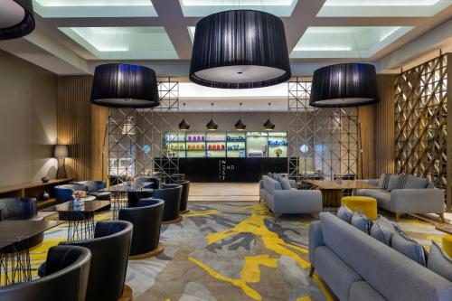 a lobby with couches and tables and a bar at Marriott Marquis City Center Doha Hotel in Doha