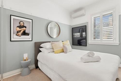 a bedroom with a large white bed and a mirror at Superb 2-Bed Apartment Facing Rose Bay Marina in Sydney