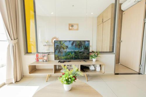 a living room with a television on a table at The Sóng Vũng Tàu- SAO VIỆT Căn Hộ Nghỉ Dưỡng 5 Sao in Vung Tau
