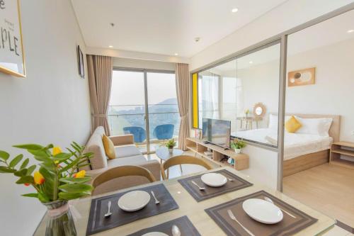a living room with a dining table and a bedroom at The Sóng Vũng Tàu- SAO VIỆT Căn Hộ Nghỉ Dưỡng 5 Sao in Vung Tau
