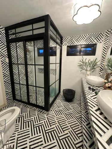 a bathroom with a black and white patterned floor at South Pearl Villas 