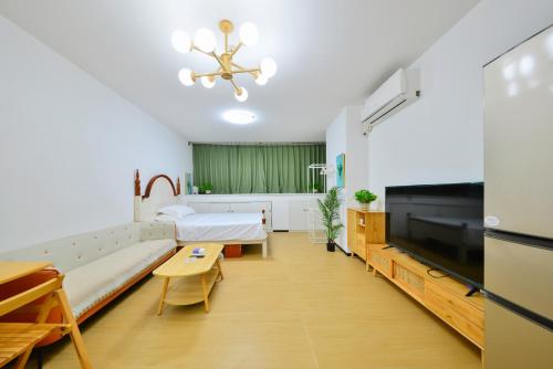 a hospital room with a couch and a tv at House of Great White Apartment in Shenzhen