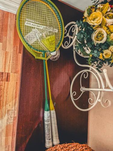 two tennis rackets are hanging on a wall at Insta-Worthy Swiss House Staycation Crosswinds Tagaytay in Tagaytay