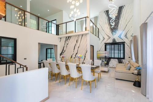 a dining room with a long table and chairs at Psalms 23 Residence in Bangkok