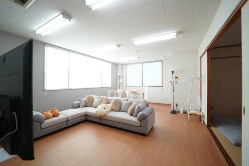 a living room with a white couch in a room at 浜ノ町瀬戸凪 in Takamatsu