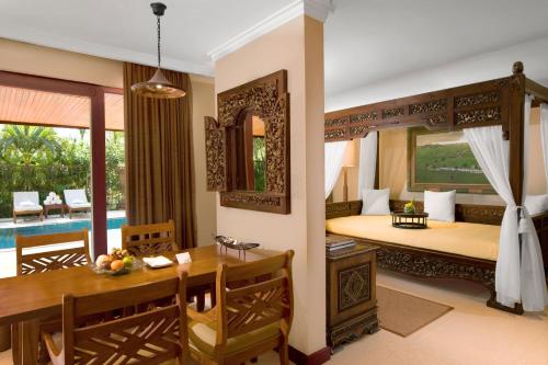 a living room with a dining table and a bedroom at The Westin Resort Nusa Dua, Bali in Nusa Dua