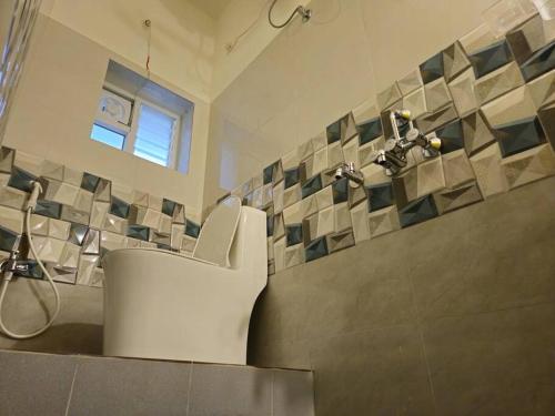 a bathroom with a sink and a shower in a room at Bricknest hillview in Mysore