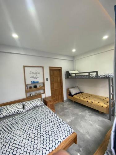 a bedroom with two bunk beds in a room at Kidapawan Staycation 2 in Manongol