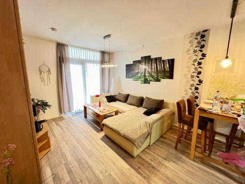 a living room with a couch and a table at RuheZeit - inclusive Pool & Sauna in Bad Harzburg