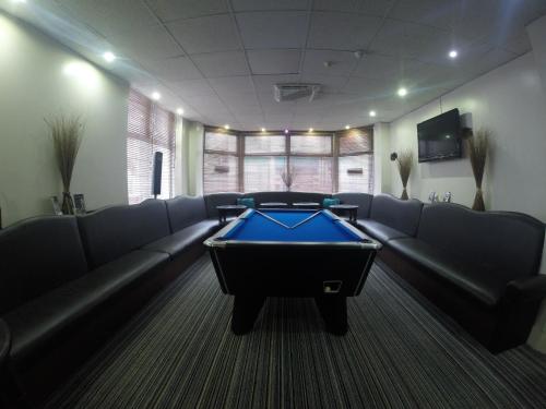 a conference room with a pool table in the middle at Happy Return Hotel in Blackpool