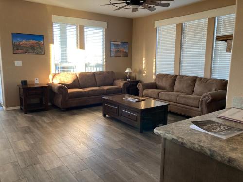 a living room with two couches and a table at NEW! The Grand Getaway at Williams - Family Friendly & Walk to the GC Train in Williams