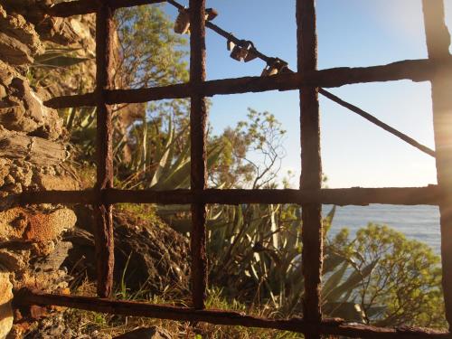 a window view of the ocean from a stone building at Zia Letizia Bed And Wine in Monterosso al Mare