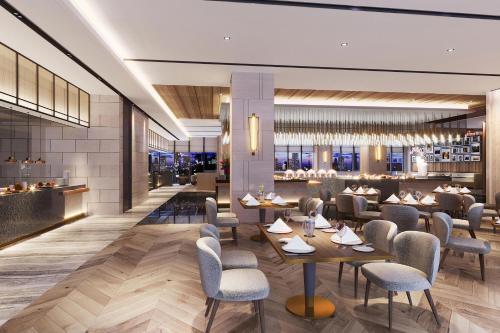 a rendering of a restaurant with tables and chairs at Four Points by Sheraton Jiaxing in Jiaxing