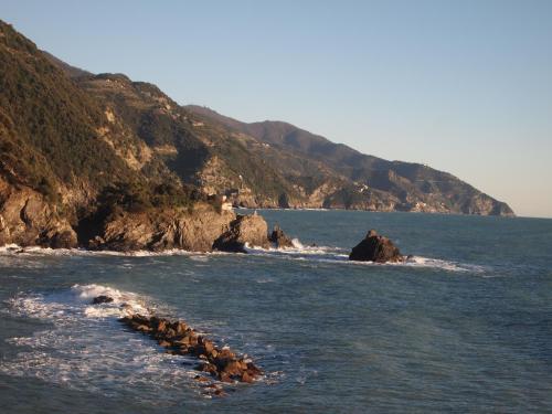 a body of water with rocks in the ocean at Zia Letizia Bed And Wine in Monterosso al Mare