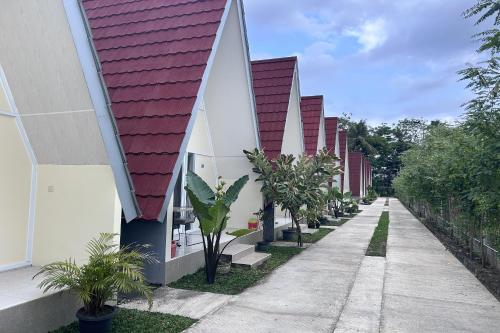 a row of houses with red and white roofs at Annet Homestay Yogyakarta in Balong