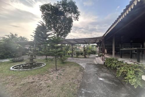 a building with a tree in front of it at Annet Homestay Yogyakarta in Balong