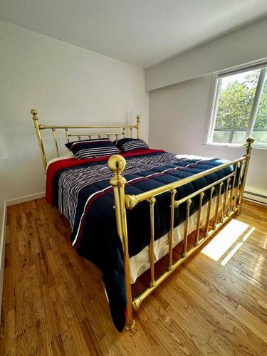 a bedroom with a bed with a wooden floor at Charming East Van Home Near DT and Commercial St in Vancouver