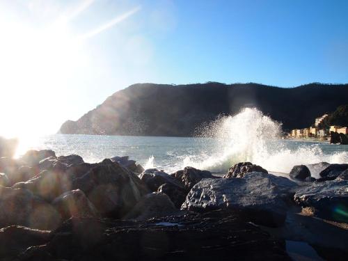 a body of water with waves crashing on the rocks at Zia Letizia Bed And Wine in Monterosso al Mare