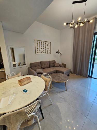 a living room with a couch and a table and chairs at Apartments 100 m2 in Sharjah