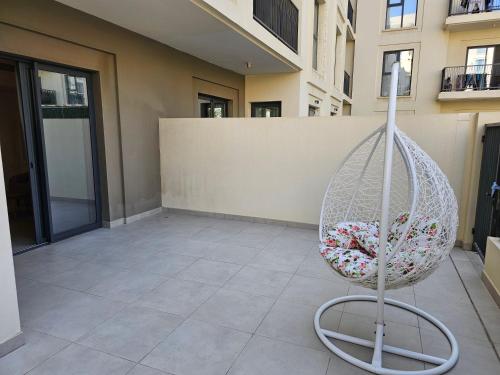 a basket of flowers sitting on a patio in a building at Apartments 100 m2 in Sharjah