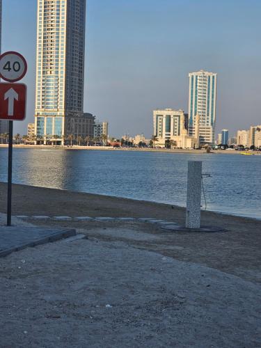 a sign on the beach next to a body of water at Apartments 100 m2 in Sharjah