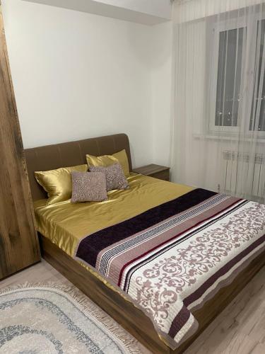 a bedroom with a large bed with at Самрук Towers,жилой комплекс in Taldykolʼ