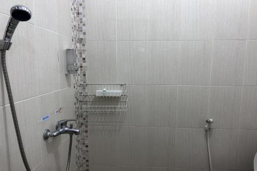 a bathroom with a shower with a shower head at Annet Homestay Yogyakarta in Balong