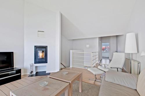 a living room with a couch and a table at Beautiful Two Story Apartment With Panoramic Views Of Ebeltoft Bay in Ebeltoft