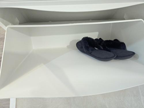 a pair of shoes in a white drawer at Marianne, Apartament 2 Camere, Viilor 9 in Chiajna