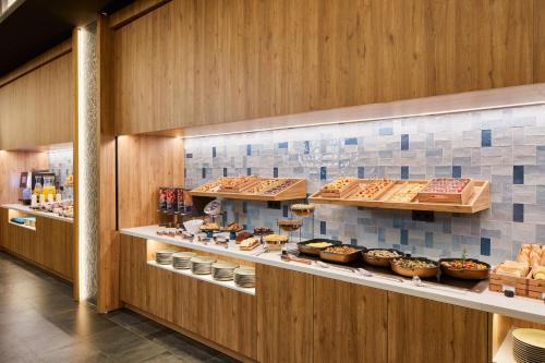 a bakery with many different types of pastries on display at Four Points by Sheraton Barcelona Airport in Barcelona