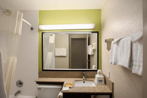 a bathroom with a sink and a mirror at Days Inn by Wyndham Rome Downtown in Rome