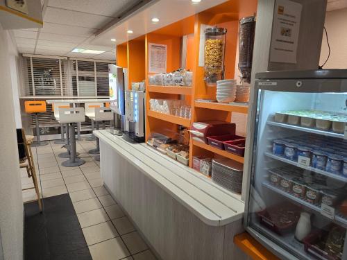a store with a counter with an open refrigerator at Première Classe Clermont-Ferrand Aubière in Aubière