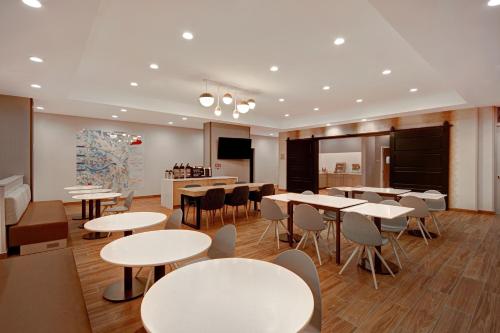 a dining room with tables and chairs and a podium at TownePlace Suites by Marriott Cincinnati Airport South in Florence