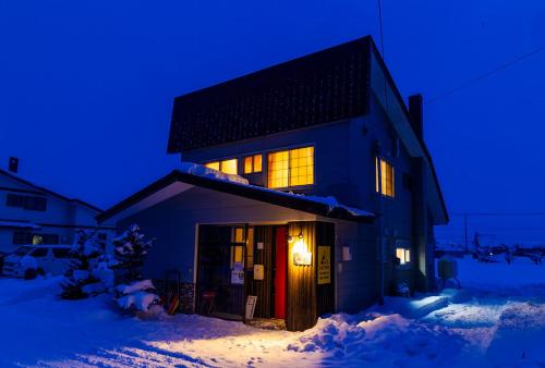 a house in the snow at night at A-JA in Niki