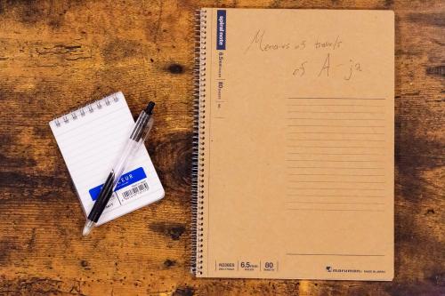a notebook with pens and a note book on a table at A-JA in Niki