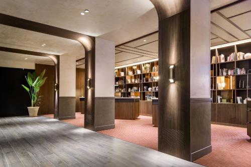 a lobby with a library with shelves of books at The Westin Madrid Cuzco in Madrid