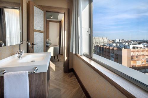 a bathroom with a sink and a large window at The Westin Madrid Cuzco in Madrid
