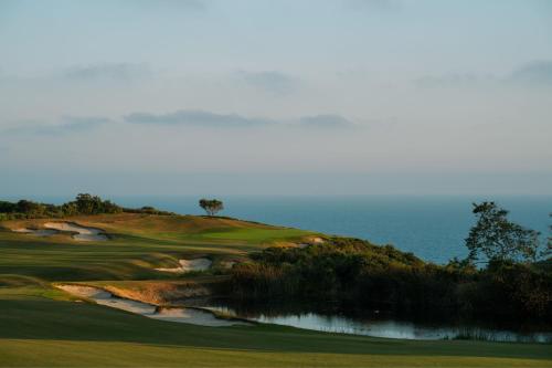 a golf course with the ocean in the background at The Resort at Pelican Hill in Crystal Cove