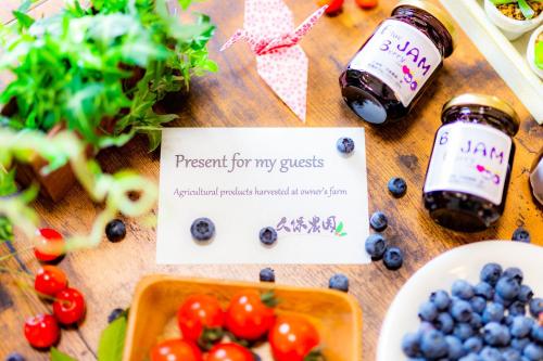 a table topped with berries and jars of food at A-JA in Niki
