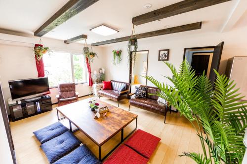 a living room with a coffee table and a tv at A-JA in Niki